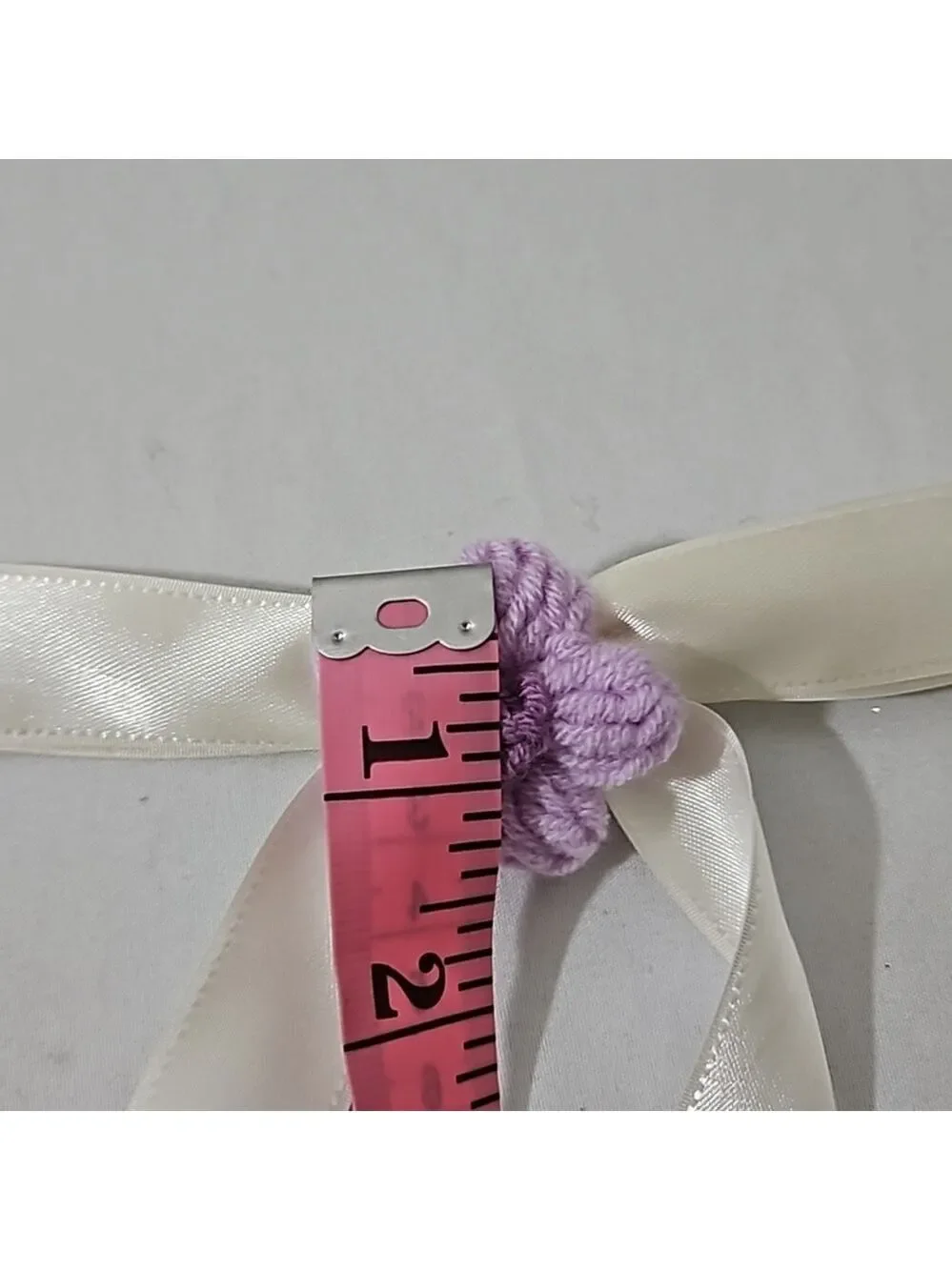 Hand Crafted Ivory Bow with Purple Crochet Flower